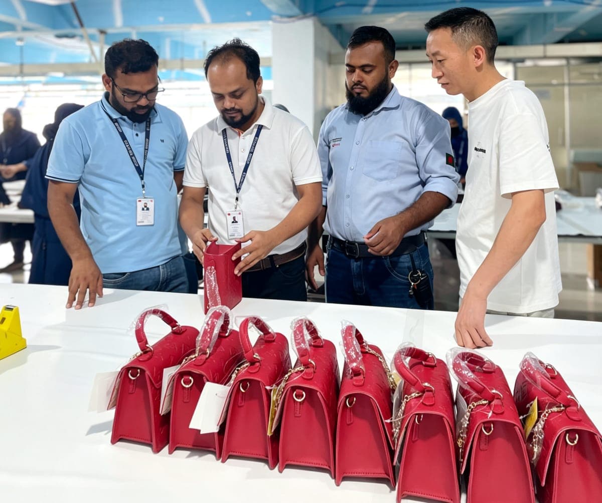 Quality team inspecting a finished run of handbags on the inspection table